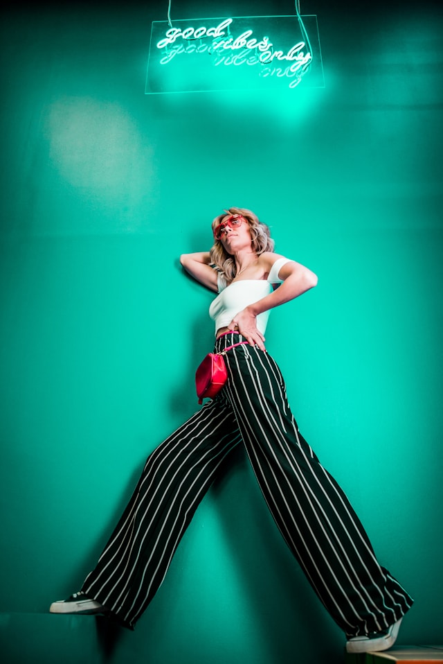 IP fashion guide, unregistered forms of protection, image of woman wearing striped trousers, green background