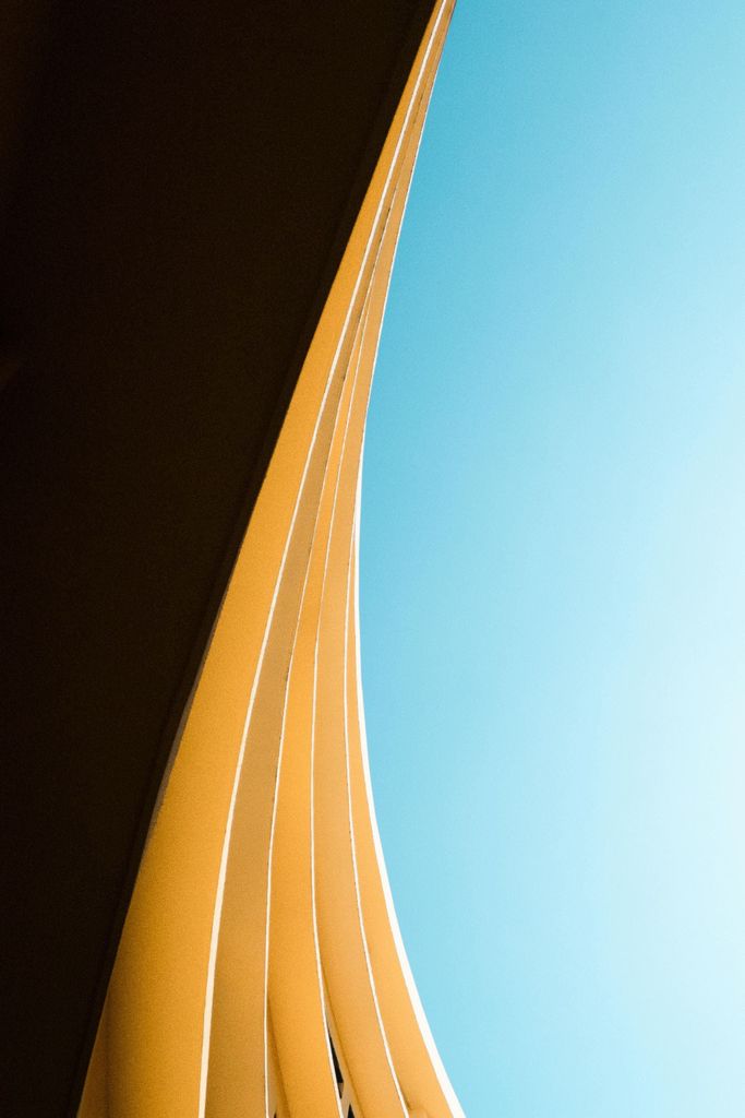 Trademark management service, image of curved building and blue sky